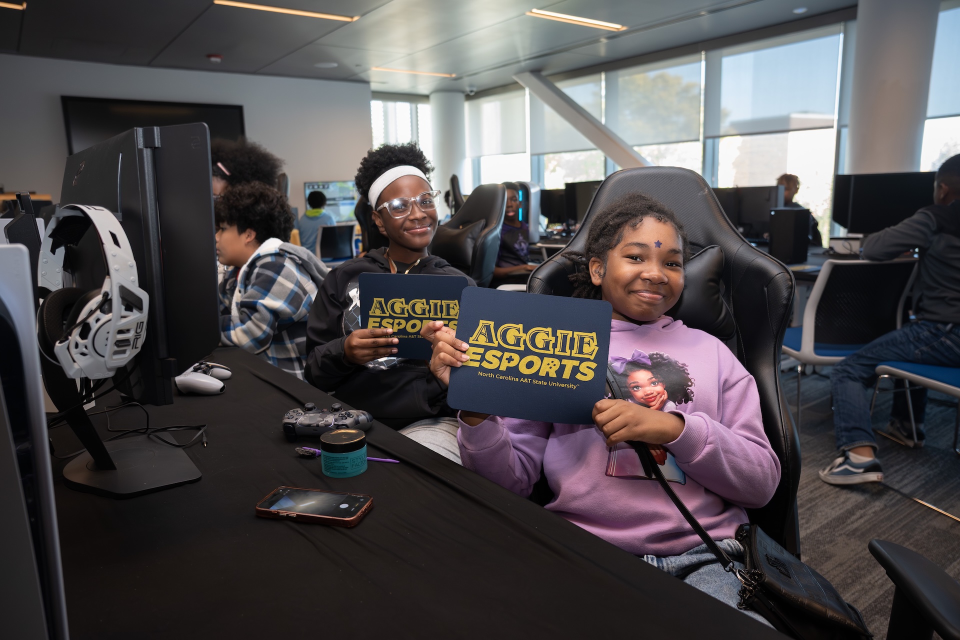 Student volunteer holding sign for 2025 Graduate Fair