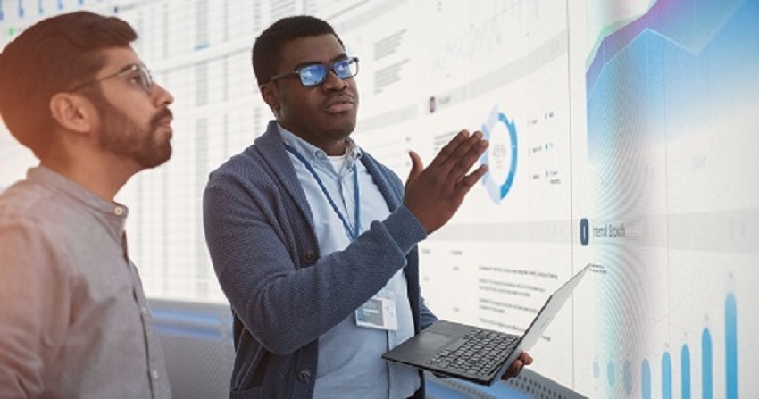 Professor and Student looking at data