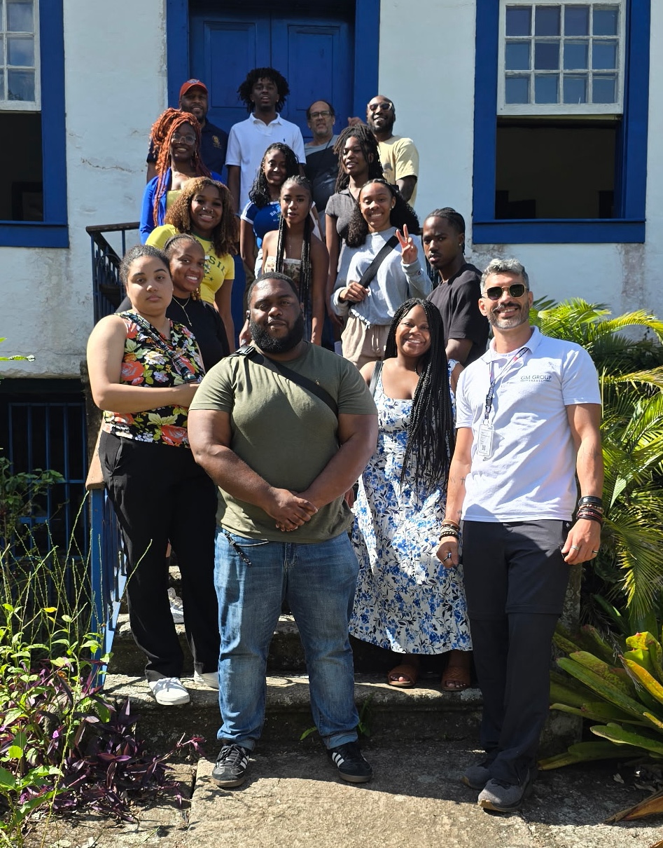 Students and Professor Antwon Foreman abroad visiting a roastery